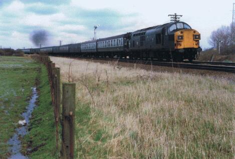37087 at Ely North Junction 37087 with up empty parcels to Cambridge. The two SKs behind were 18988 and 24846. The latter ended up at Snailwell Scrapyard a couple of months later. 18988 went onto Ferme Park eventually being scrapped at Vic Berry. 37087 at Ely North Junction 37087 with up empty parcels to Cambridge. The two SKs behind were 18988 and 24846. The latter ended up at Snailwell Scrapyard a couple of months later. 18988 went onto Ferme Park eventually being scrapped at Vic Berry.